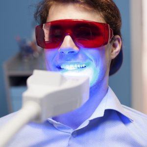 Male getting teeth whitening