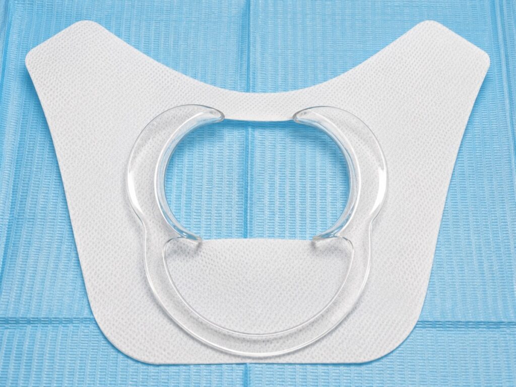 Saliva Shield goes around retractor, makes width smaller in clients mouth & it’s for dribblers